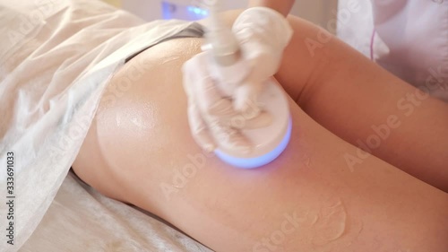 Hardware cosmetology. Body care. Spa treatment. Ultrasound cavitation body contouring treatment. Woman getting anti-cellulite and anti-fat therapy in beauty salon.