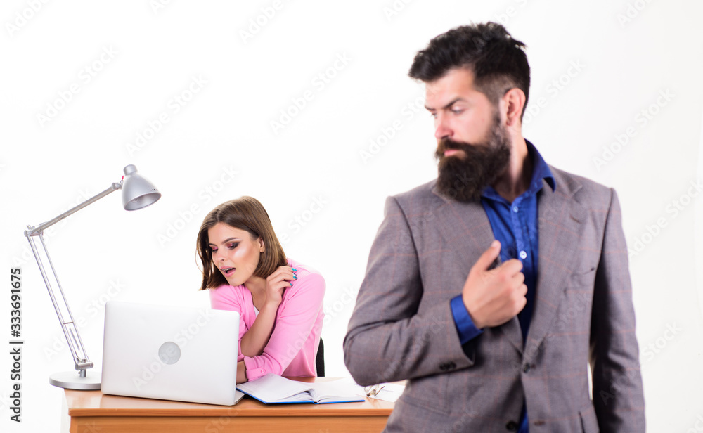 Fototapeta premium Typical office life. Office collective concept. Working together. Manager boss stand in front of girl busy with laptop. Office manager or secretary. Sexy lady office worker. Personal secretary