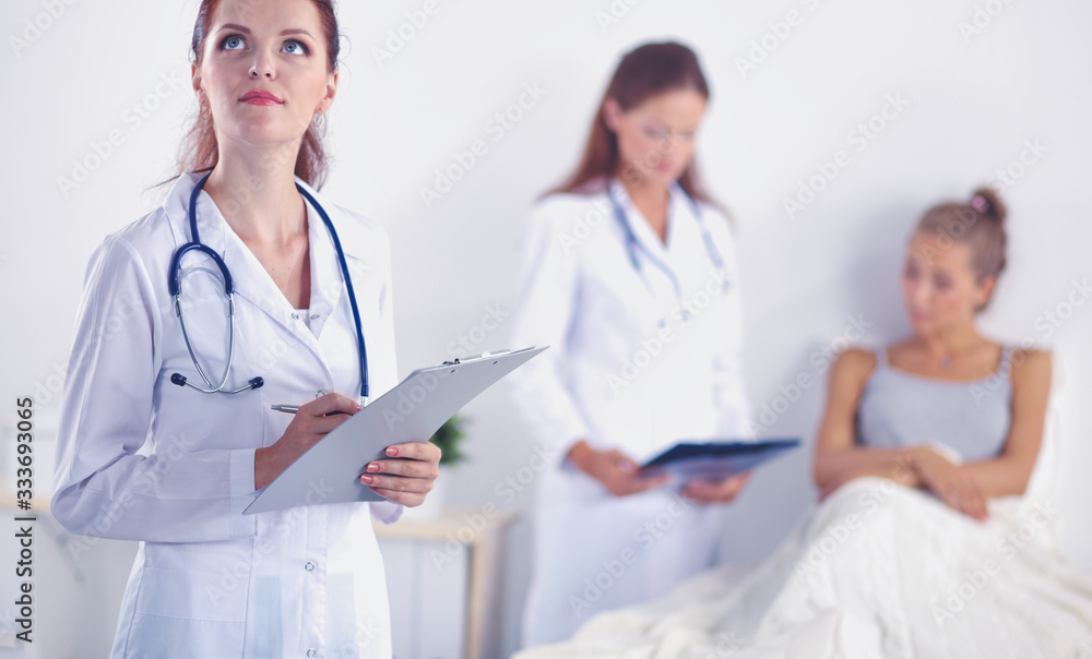 Woman doctor with folder standing at hospital. Woman doctor Woman doctor with folder standing at hospital. Woman doctor