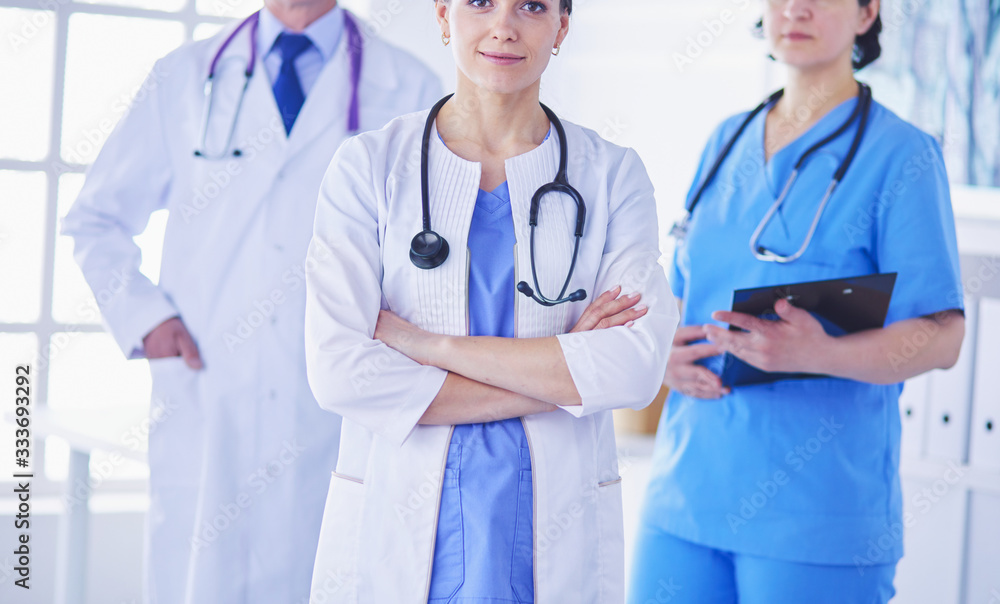 Group of doctors and nurses standing in the hospital room Group of doctors and nurses standing in the hospital room