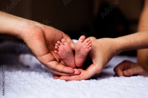 hands of mother and baby feet