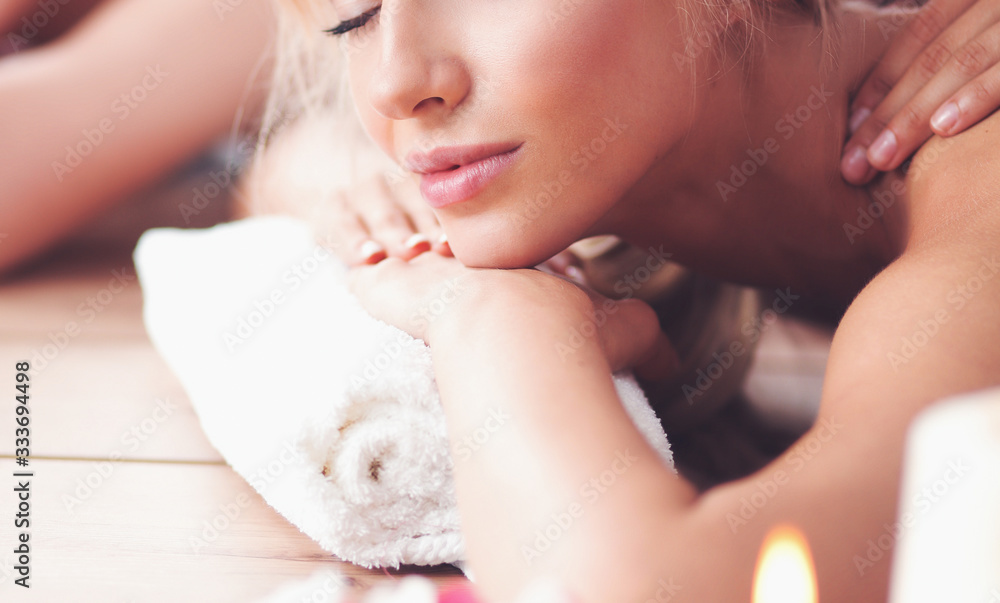 Two beautiful women getting massage in spa Two beautiful women getting massage in spa