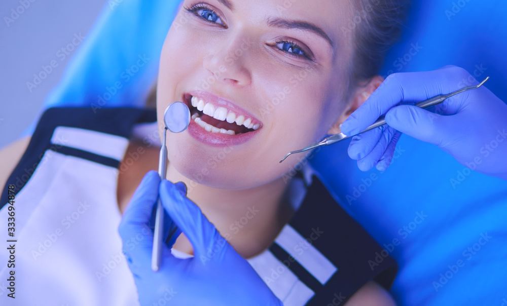 Young Female patient with open mouth examining dental inspection at dentist office. Young Female patient with open mouth examining dental inspection at dentist office.
