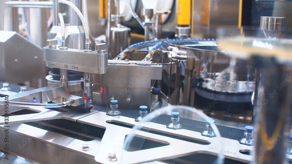 Automatic packaging machine for packaging ampoules with vaccine, injection and medical drugs. coronavirus. Automatic packaging machine for packaging ampoules with vaccine, injection and medical drugs. coronavirus.