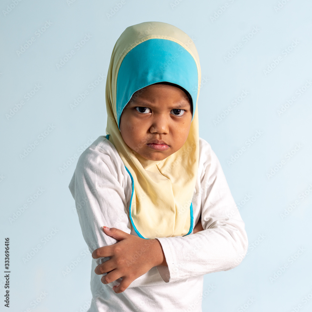 Angry Muslim girl wearing hijab isolated portrait. Shallow depth of field Angry Muslim girl wearing hijab isolated portrait. Shallow depth of field