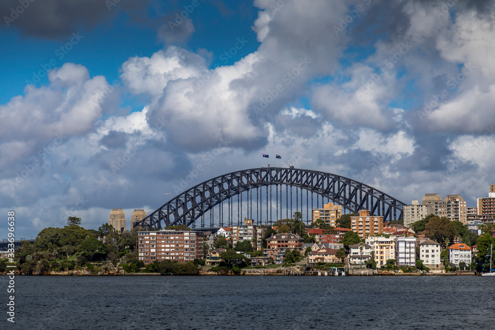 Fototapeta premium The Harbour Bridge in Sydney, New South Wales, Australia during a cloudy but warm day in summer.