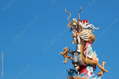Wallpaper Mural Decorative dragon sculpture with lantern adorns a pole at a Chinese temple in southeast Asia Torontodigital.ca