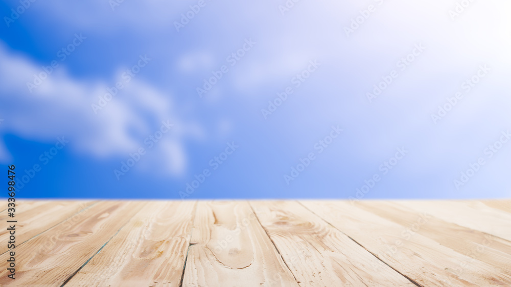 Wooden surface against blue sky with clouds