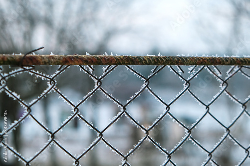 A white fence which has become rusted