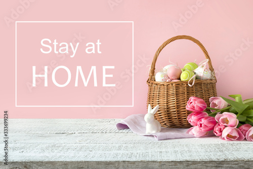 Canvas Print Wicker basket with easter eggs and pink tulips