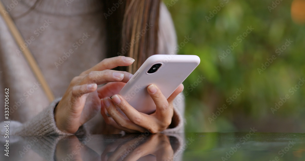 Woman uses of mobile phone at park Woman uses of mobile phone at park