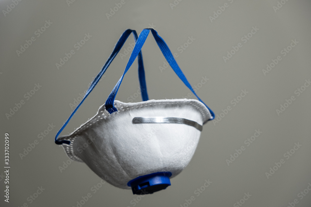 Floating surgical mask on a simple background