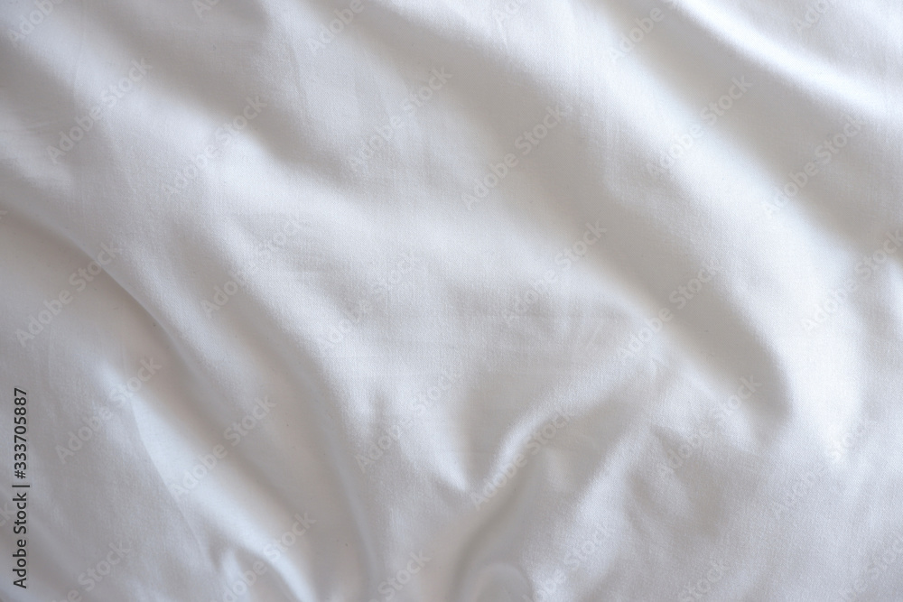 Soft white blanket. The sun's rays fall on the bed linen. Cosiness Soft white blanket. The sun's rays fall on the bed linen. Cosiness