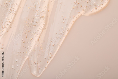 Photographie Pure transparent cosmetic gel on beige background, top view