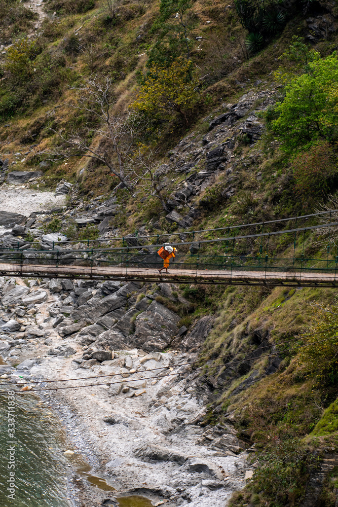 Naklejka premium A man walking in a River bridge