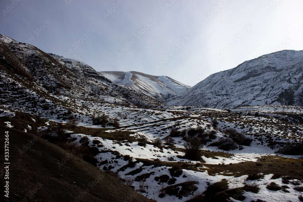 Caucasus Mountains in winter. Landscape of the rocky Caucasus mountains in winter. Landscape of the rocky Caucasus mountains against the sky. Rocky mountains in winter. mountains in winter