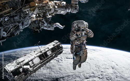 Fototapeta Naklejka Na Ścianę i Meble -  Astronauts, space stations in orbit of the Earth. Solar system. Science fiction. Elements of this image furnished by NASA