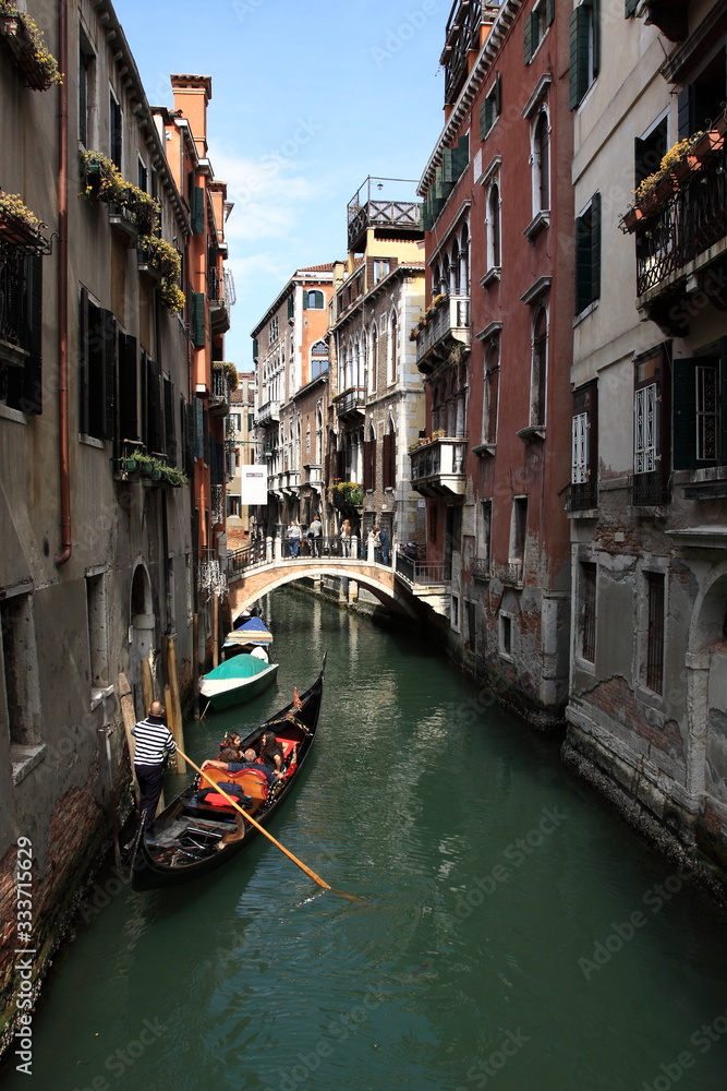 Gondola floats on a narrow canal in Venice
