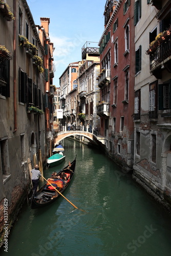 Gondola floats on a narrow canal in Venice