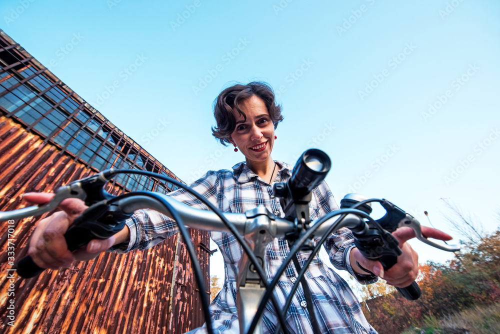 carefree smiling girl cycling. the best solution to escape from a coronavirus