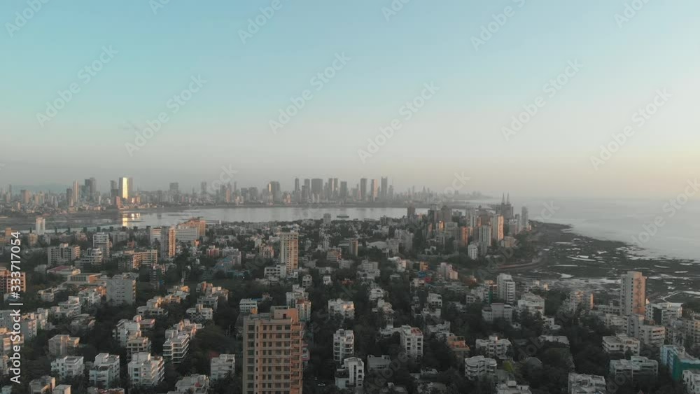 Rising Drone shot over Bandra Mumbai forested city looking towards large highrise skyscraper buildings Rising Drone shot over Bandra Mumbai forested city looking towards large highrise skyscraper buildings