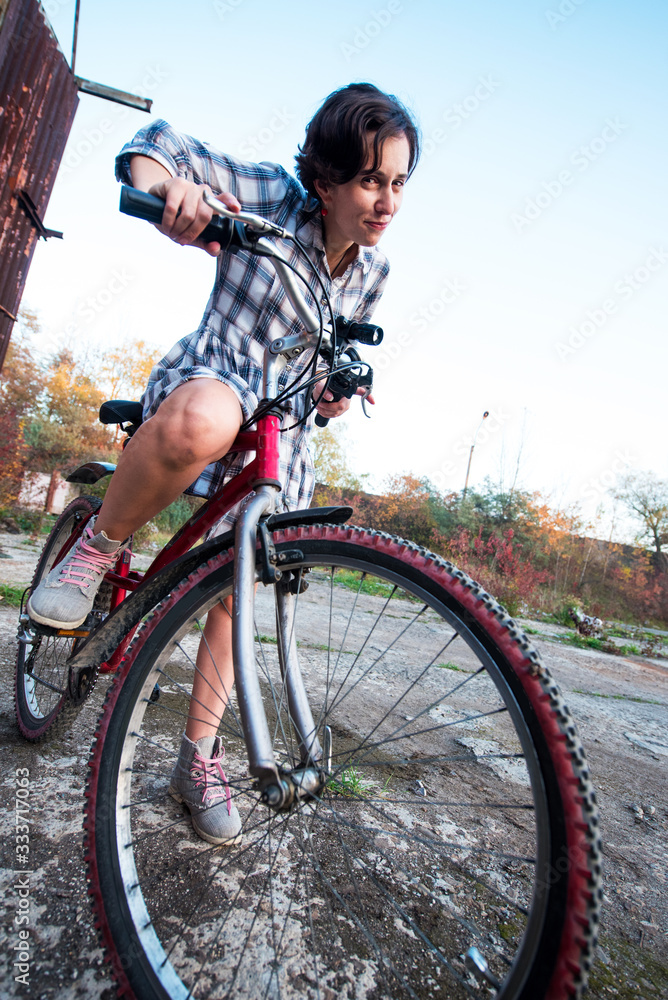 carefree smiling girl cycling. the best solution to escape from a coronavirus
