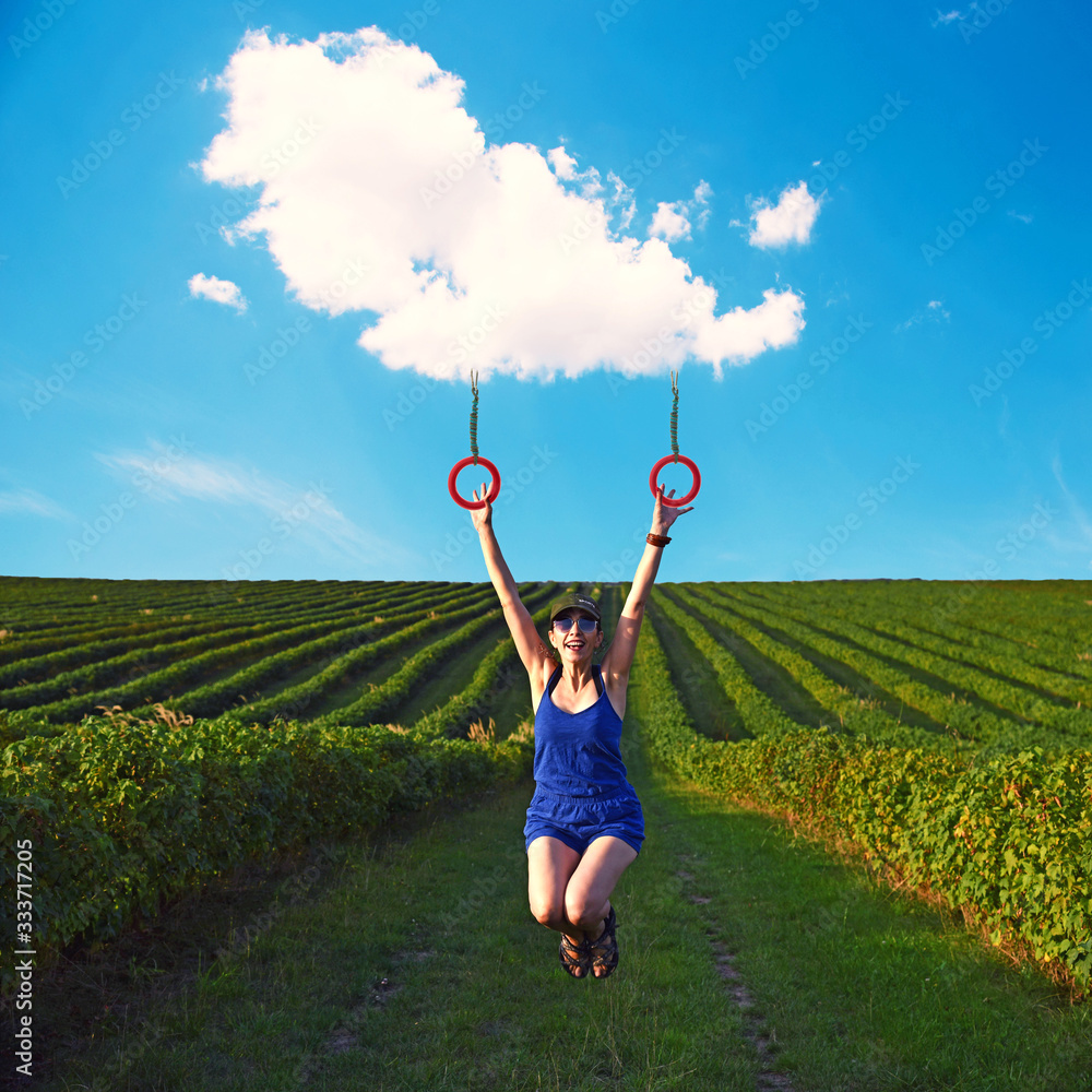 inspiring collage with a carefree girl riding a cloud in the middle of the field. the best solution to escape from a coronavirus