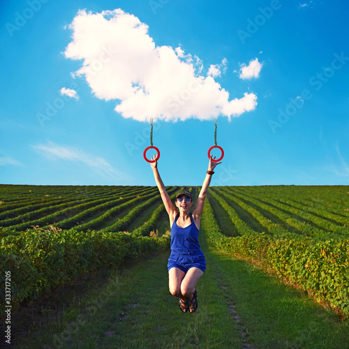 Obraz na płótnie inspiring collage with a carefree girl riding a cloud in the middle of the field. the best solution to escape from a coronavirus w salonie
