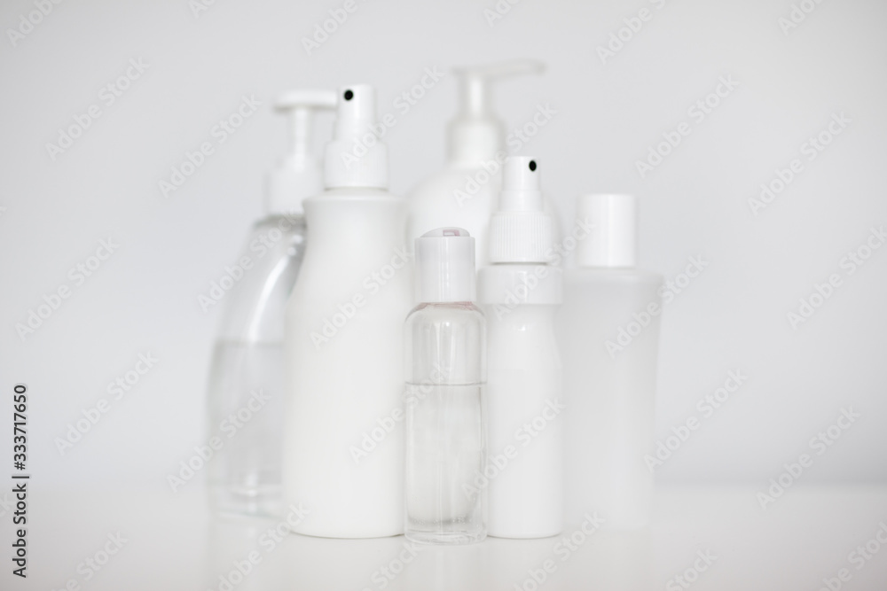many different hand sanitizer bottles over white many different hand sanitizer bottles over white