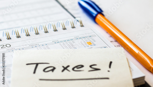 USA tax date marked on calendar close up, pen and notes, focus on planning number - 17 April