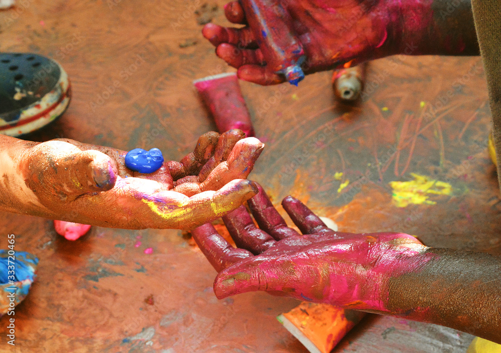 Hands of a child in paint playing on the Sun in the time of isolation background. Hands of a child in paint playing on the Sun in the time of isolation background.
