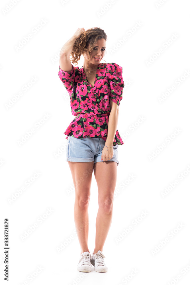 Alluring sexy young happy confident woman in casual summer style clothes touching curly hair. Full body isolated on white background. Alluring sexy young happy confident woman in casual summer style clothes touching curly hair. Full body isolated on white background.