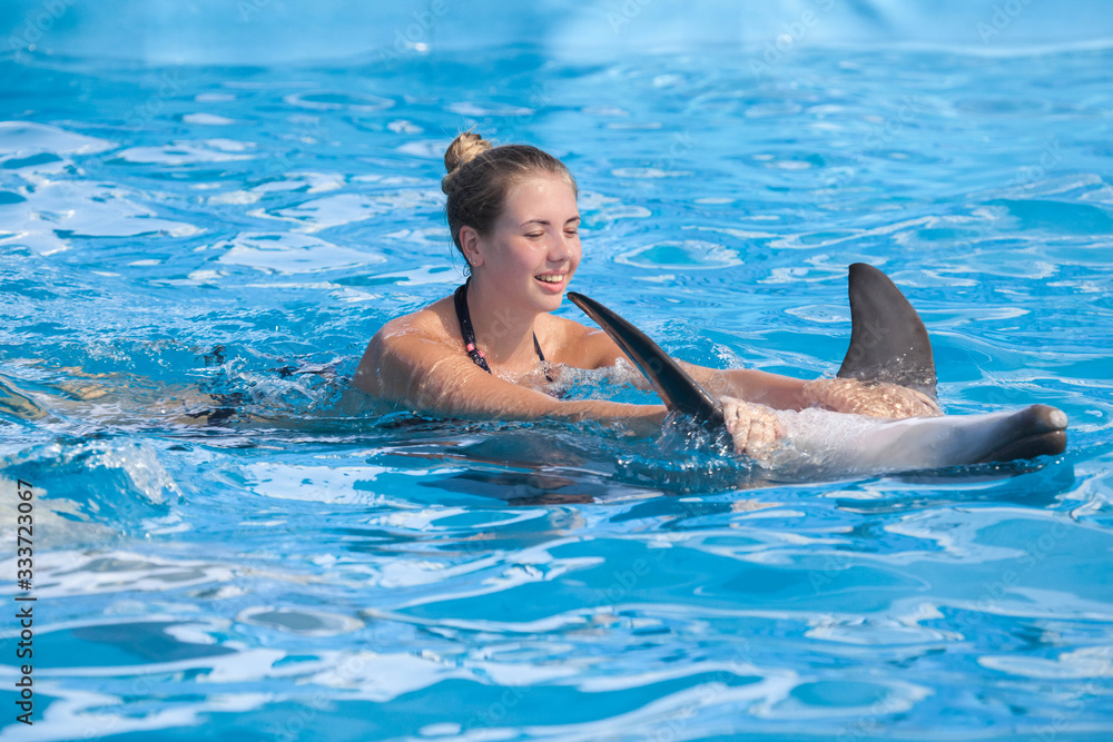 Girl swimming with dolphin