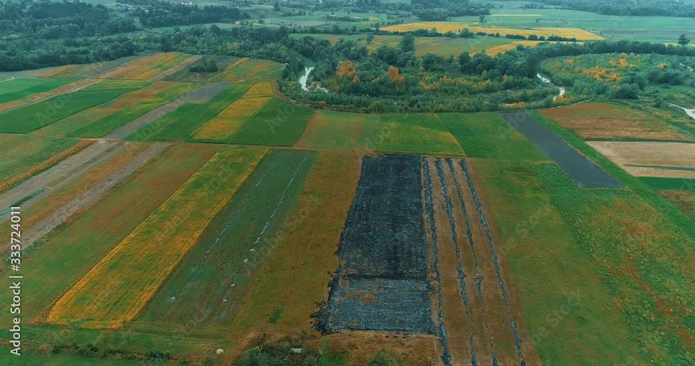 Contrast with burned section among harvested fields in autumn countryside. Contrast with burned section among harvested fields in autumn countryside.