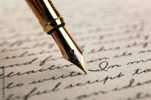 fountain pen on paper with ink text on a white background