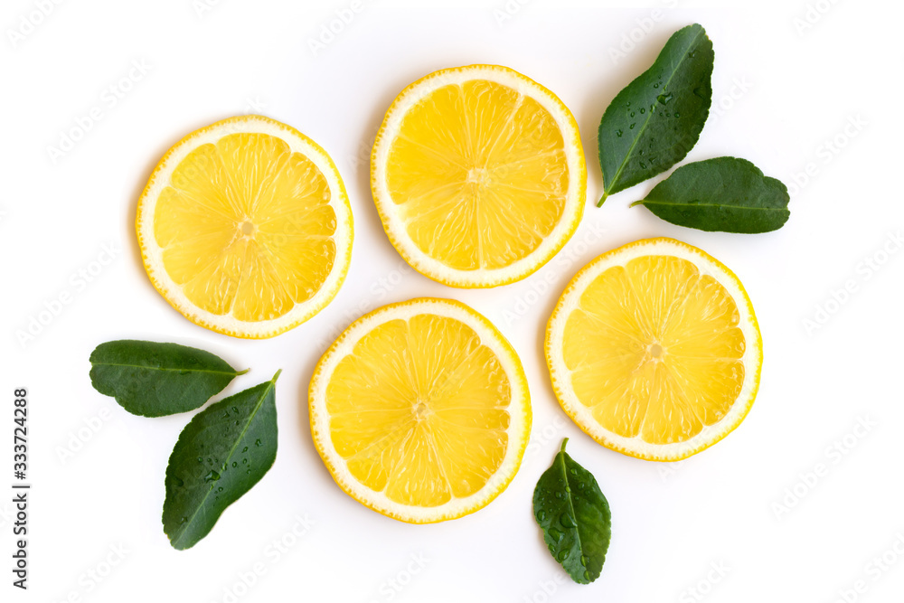Fototapeta premium Fresh slices of yellow lemon lime fruit with green leaf isolated on white background . Top view.