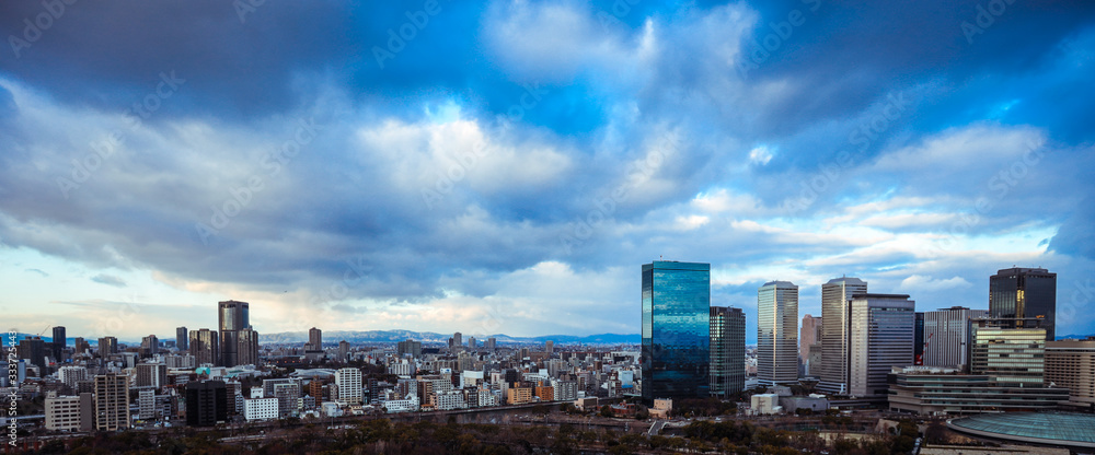 Osaka, Japan - January 07, 2020: Panoramic View to the Evening City from the Castle Roof Osaka, Japan - January 07, 2020: Panoramic View to the Evening City from the Castle Roof