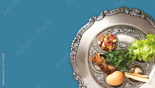 Pesach plate on a petrol blue background. Traditional Jewish seder on the occasion of Passover festival. photo