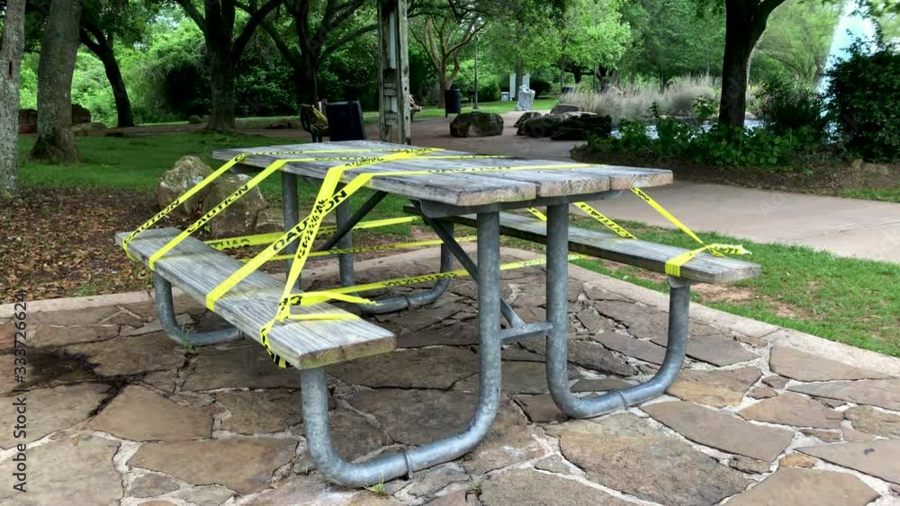A public park picnic table taped off after lock down mandate issued due to the coronavirus COVID19 pandemic. A public park picnic table taped off after lock down mandate issued due to the coronavirus COVID19 pandemic.