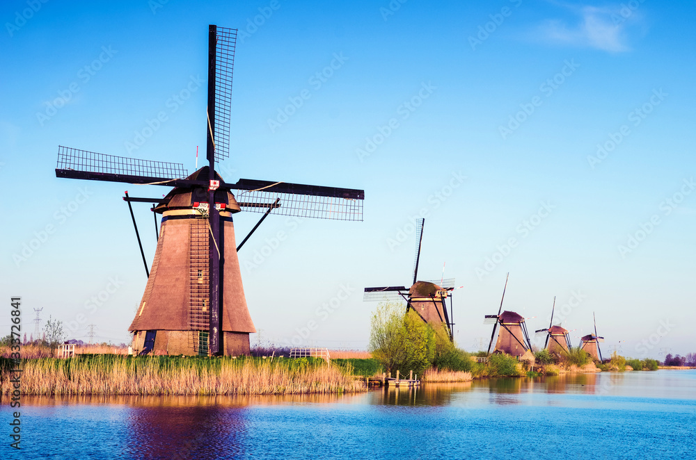 breathtaking beautiful inspirational landscape with windmills in Kinderdijk, Netherlands. Fascinating places, tourist attraction.