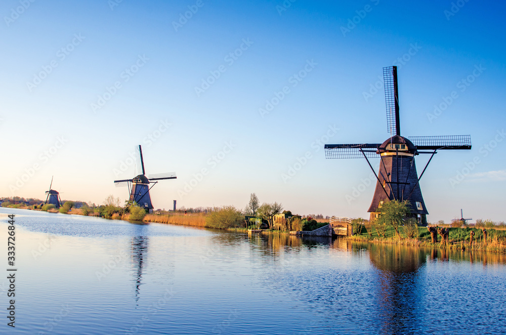 breathtaking beautiful inspirational landscape with windmills in Kinderdijk, Netherlands. Fascinating places, tourist attraction.