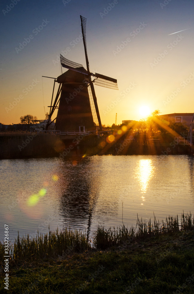 breathtaking beautiful inspirational landscape with windmills in Kinderdijk, Netherlands at sunrise. Fascinating places, tourist attraction.