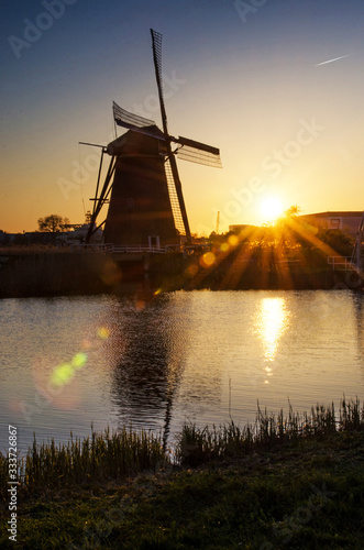 Obraz na płótnie breathtaking beautiful inspirational landscape with windmills in Kinderdijk, Netherlands at sunrise. Fascinating places, tourist attraction. w salonie