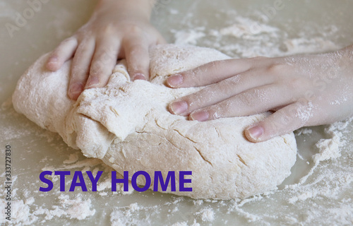 Stay at home quarantine coronavirus pandemic prevention. Making dough from flour. The child kneads the dough closeup