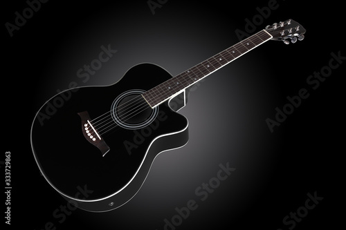guitar inclined on dark graduated background with copy space