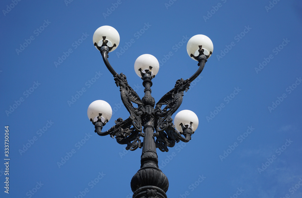 Decorative lamp post Greek revival architectural style ornamental outdoor streetlight. 