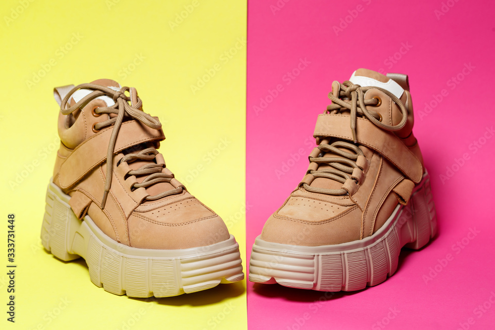 Brown women's leather shoes on a colored background. Fashion trend Brown women's leather shoes on a colored background. Fashion trend