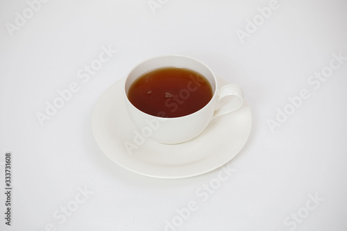white cup with tea on a white background