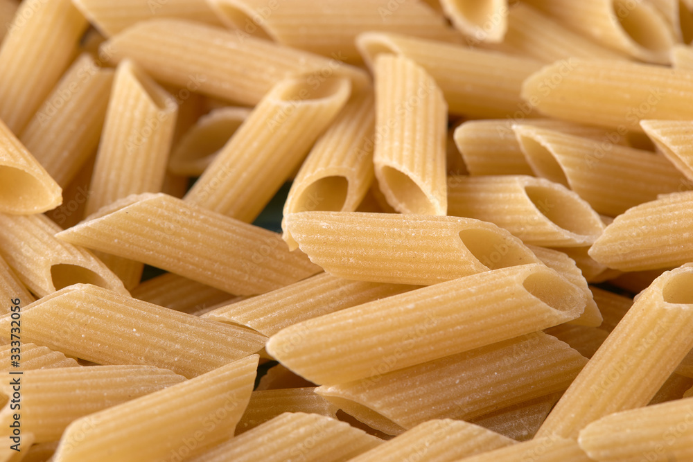 Raw pasta penne background closely Raw pasta penne background closely