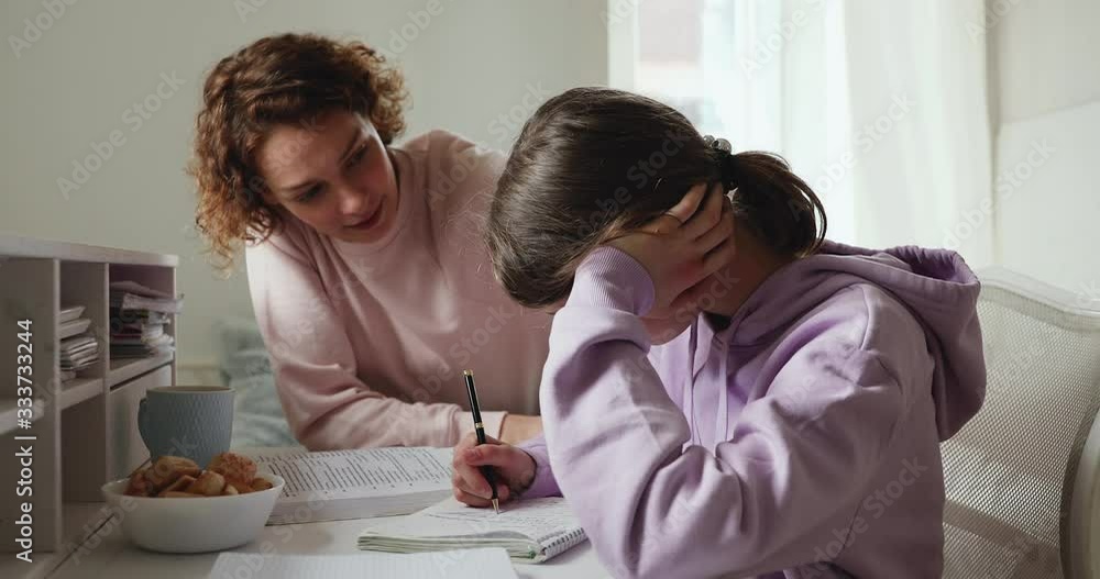 Caring young parent mom supporting tired upset teen school child daughter having difficulty with education learning at home. Mum comforting sad teenage girl encouraging helping with studies concept. Caring young parent mom supporting tired upset teen school child daughter having difficulty with education learning at home. Mum comforting sad teenage girl encouraging helping with studies concept.